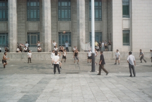 North Korean men play makeshift volleyball in Kim Il-sung square 